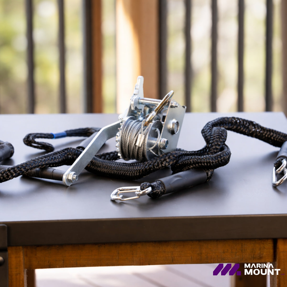 Manual winch and braided boat tie-off lines with protective sleeves and metal attachment clips