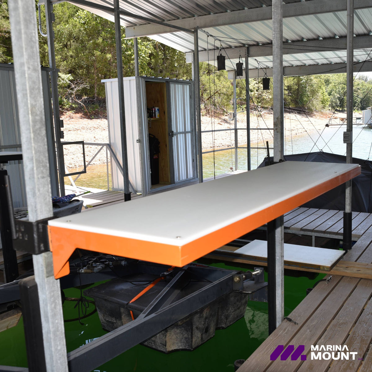 Orange Marina Mount dock table with durable HDPE tabletop installed beside a boat slip