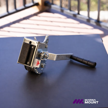 Angled view of the Marina Mount dock winch with hand crank and steel cable spool